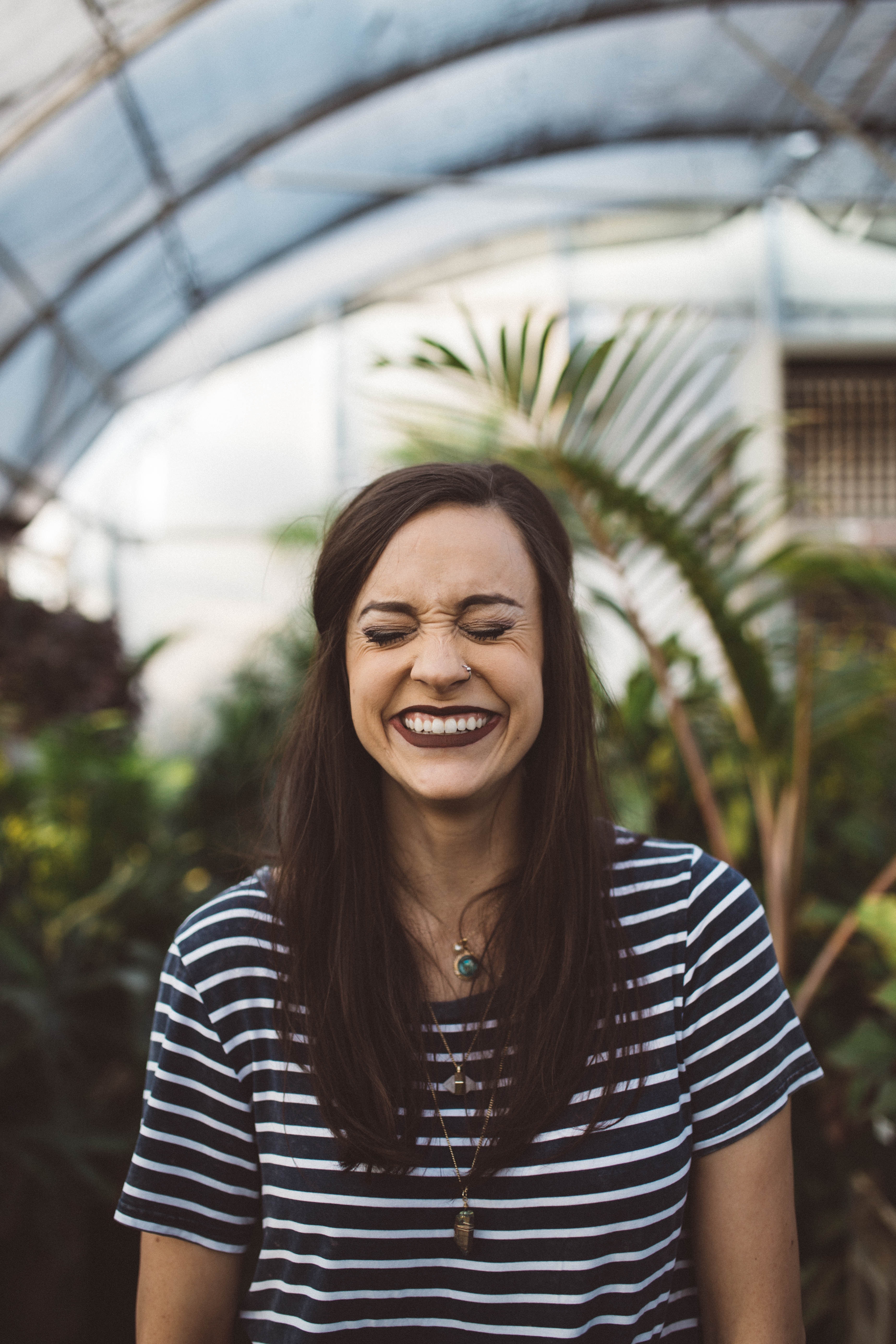 Woman laughing hysterically with closed eyes